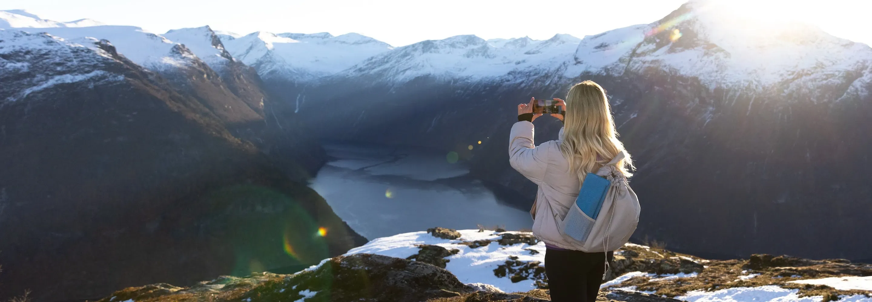 Dame med mobil på fjellet