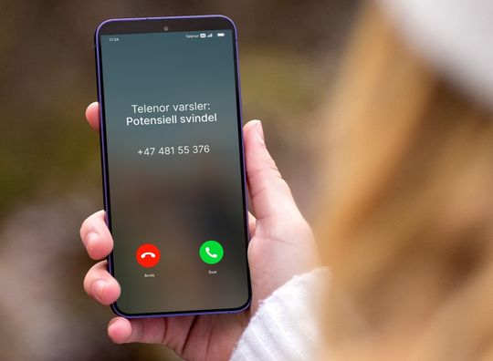 Mobil som viser Nummervarsel med anrop markert som potensiell svindel